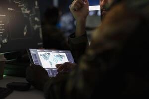 Army officers managing air traffic control using radar surveillance software on tablet. Close up of military agents following enemy units on reconnaissance satellite system using device photo