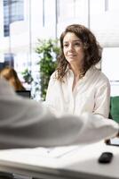 Smiling HR expert determining if candidate possesses skills and experience needed to fulfil role. Cheerful headhunter discussing with applicant, evaluating if qualifications align with company photo