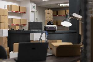 Empty depot storage room in distribution center shows workspace prepared for order processing and product handling in a local warehouse. Hand packing tasks in an inventory room. photo