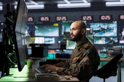 Counterterrorism division officer in command center using target acquisition tech to detect enemy location. Middle Eastern defense security agent using satellite equipment to track threats photo