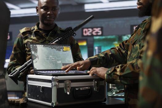 Military officer looking at surveillance footage on laptop, analyzing data to allocate resources to units based on mission needs. Intelligence agent examining strategic data on notebook screen photo