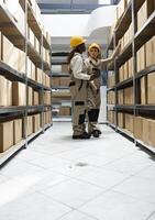 Bar code scanning for logistics handled by trained diverse staff who oversee inventory management, product movement and crate stacking for efficient delivery and supply chain operations. photo