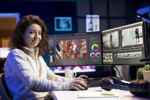 Portrait of jolly editor using special effects and editing software packages to upgrade footage shot by production teams. Happy videographer finishing project in multimedia agency photo