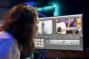editor showcasing experience with 3D special effects and editing software packages, taking footage shot by production teams and improving it. Videographer finishing project in studio photo