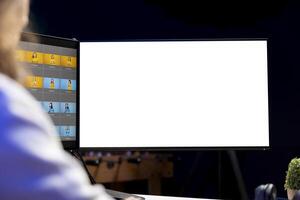 Photographer using photo editing software on mockup multi monitors setup to improve images quality. Photo editor utilizing pictures retouching application on isolated screen display