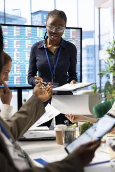 Diverse group of employees participating in a project briefing meeting, discussing workflow optimization and resource allocation. Uniting forces for a successful project execution. photo