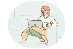 Woman sits in armchair with laptop on lap and drinks coffee enjoying relaxation in cozy home vector