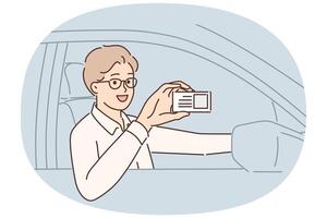 Man driving car demonstrates driver license giving right to work in taxi company vector