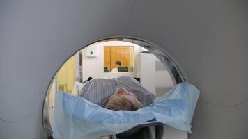 Medical professionals perform a ct scan on a patient, capturing detailed cross sectional images for accurate diagnosis and treatment planning video