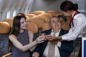 Flight attendant is serving fruit juice to the customer for in flight meal catering, airline travel and transportation usage photo