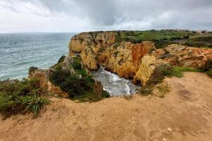 Scenic Coastal Cliffs and Rock Formations by the Sea photo