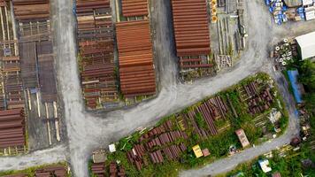 Aerial view of industrial steel pipe yard. Rusted and new construction materials. Infrastructure supply, recycling potential, and urban storage logistics. Sustainable infrastructure management. photo