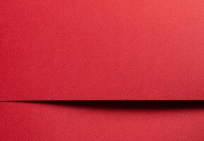 Elegant red paper sheet with smooth matte texture. Bright, festive background with minimalistic photo