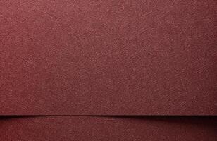Metallic paper background closeup. Monochrome red and marsala sheets with shiny gradient, glossy photo