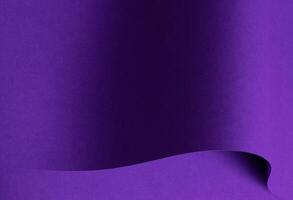 Designer paper in bright and dark violet purple tones with wavy folds and curved shapes. Matte photo