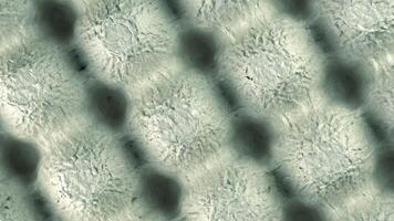 Abstract texture with a gray background. The surface features a pattern of soft, rounded shapes creating a subtle depth effect. video