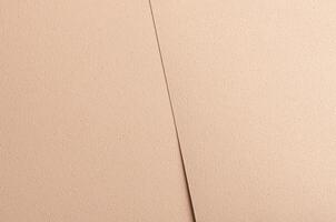 Elegant background with overlapping sheets of beige and cream designer paper. Geometric shapes with photo