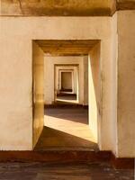 Ancient sandstone portal with arch, creating a passage through time. Symmetrical doorway, light and photo