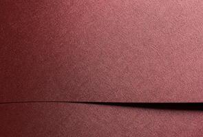 Chic paper closeup. Monochrome red and marsala surface with metallic gloss, geometric overlap, photo