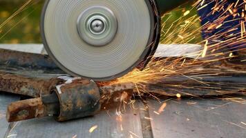 A close-up of a grinding wheel in action, producing sparks while grinding a metal surface. The scene captures the intensity of metalworking. video