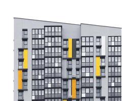 Tall apartment building with geometric facade and multiple windows. Modern condominium structure photo
