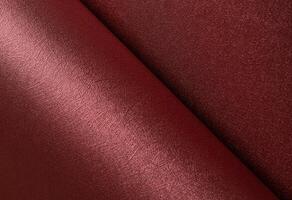Designer paper closeup. Elegant red and marsala surface with pearlescent metallic gloss, smooth photo