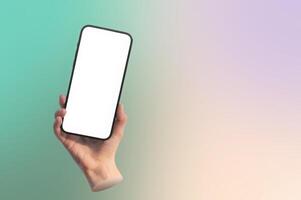 Hand holding mobile phone with blank screen for app display. Smartphone mockup used for advertising, photo