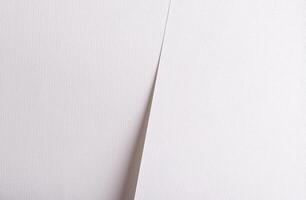 A clean, elegant white paper texture with a subtle woven structure, offering a refined and minimal photo