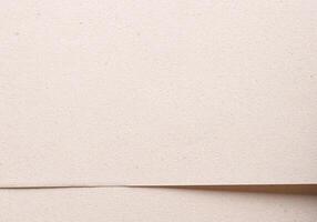 Modern background with overlapping sheets of premium beige and cream paper. Soft grainy texture, photo