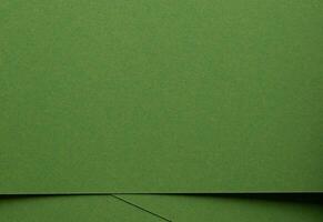 Monochrome green paper texture. Matte surface with smooth fiber detail, geometric overlap of organic photo