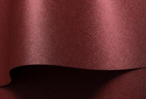Chic paper background in red and marsala. Pearlescent metallic surface with glossy folds, wavy photo