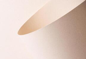 Curved sheet of elegant designer paper in creamy beige tones with tactile porous texture and organic photo