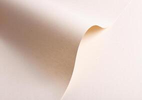 Elegant designer paper in creamy beige tones with folded and wavy shape. Natural recycled material photo