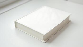 A blank white hardcover book lying on a white surface in soft natural light Generated using AI photo
