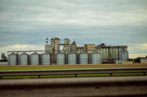 A large building with many silos in the background photo
