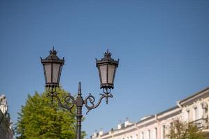 A street lamp on a street in front of a building photo