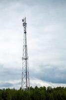 A cell phone tower in the middle of a field photo
