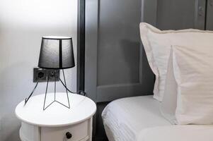 A white bed with white sheets photo