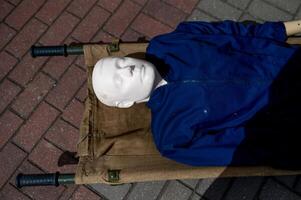 A mannequin laying on a stretcher photo