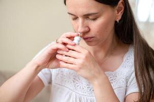 A woman is using an inhaler photo