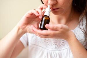 A woman is holding an essential oil bottle photo