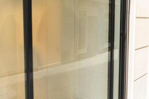 Reflective shop window with neutral tones and blurred background, great for branding mockups, store visuals or advertising real estate content photo