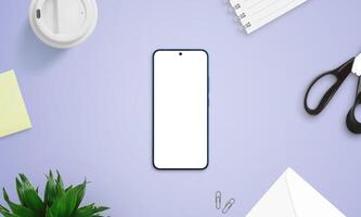 Top view of smartphone mockup on purple desk with creative items like scissors, sticky notes, coffee cup, and notebook photo