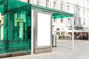 Vertical outdoor mockup at modern glass bus station with copy space, suitable for public information, ads or branding photo