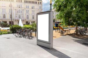 Empty city billboard mockup in square with bikes and fountain, ideal for advertising, promotions or commercial poster designs photo
