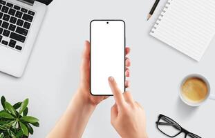 Flat lay scene with smartphone mockup in hand, touch gesture in progress, perfect for showcasing mobile interface, app design or creative workspace photo
