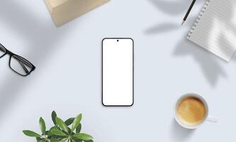 Smartphone mockup on soft-lit desk with coffee, glasses, notebook, and shadows. Perfect for natural presentation of apps and digital content photo