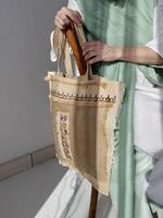 woman holding bag with a pattern on it photo