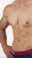 Muscular man with perfect abs flexing his muscles in a dynamic pose video