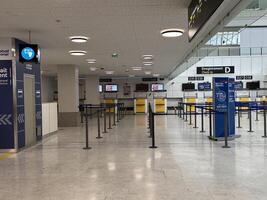 Nice, France - May 10, 2025 Airport terminal interior with empty check-in counters and signage, showcasing modern design and spacious layout with copy space for travel-related content photo